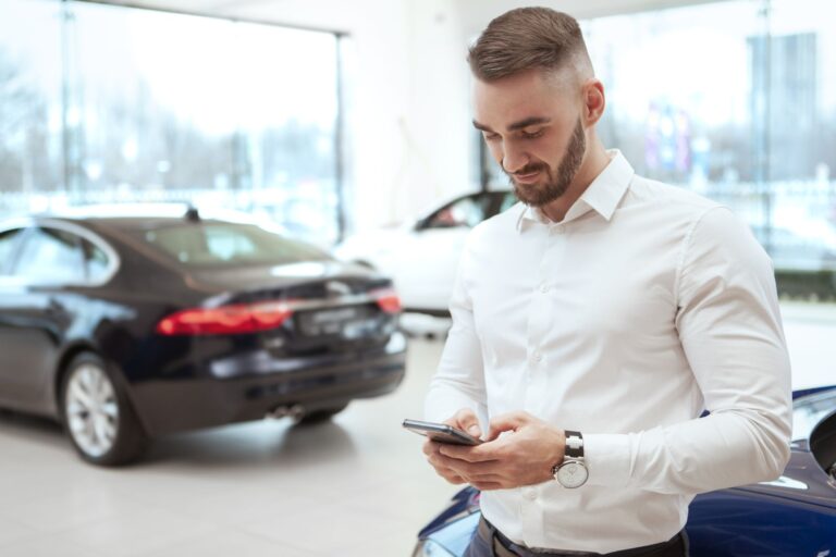 A Man Looking At A Cellphone