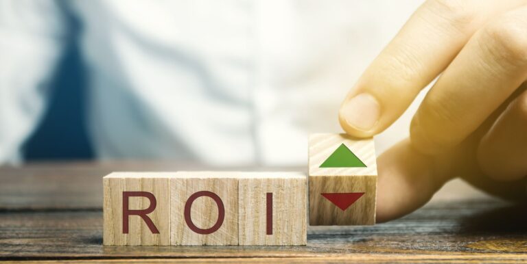 A Hand Holding A Wooden Block With A Arrow And Arrow Pointing Up