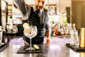 a man pouring a drink into a glass