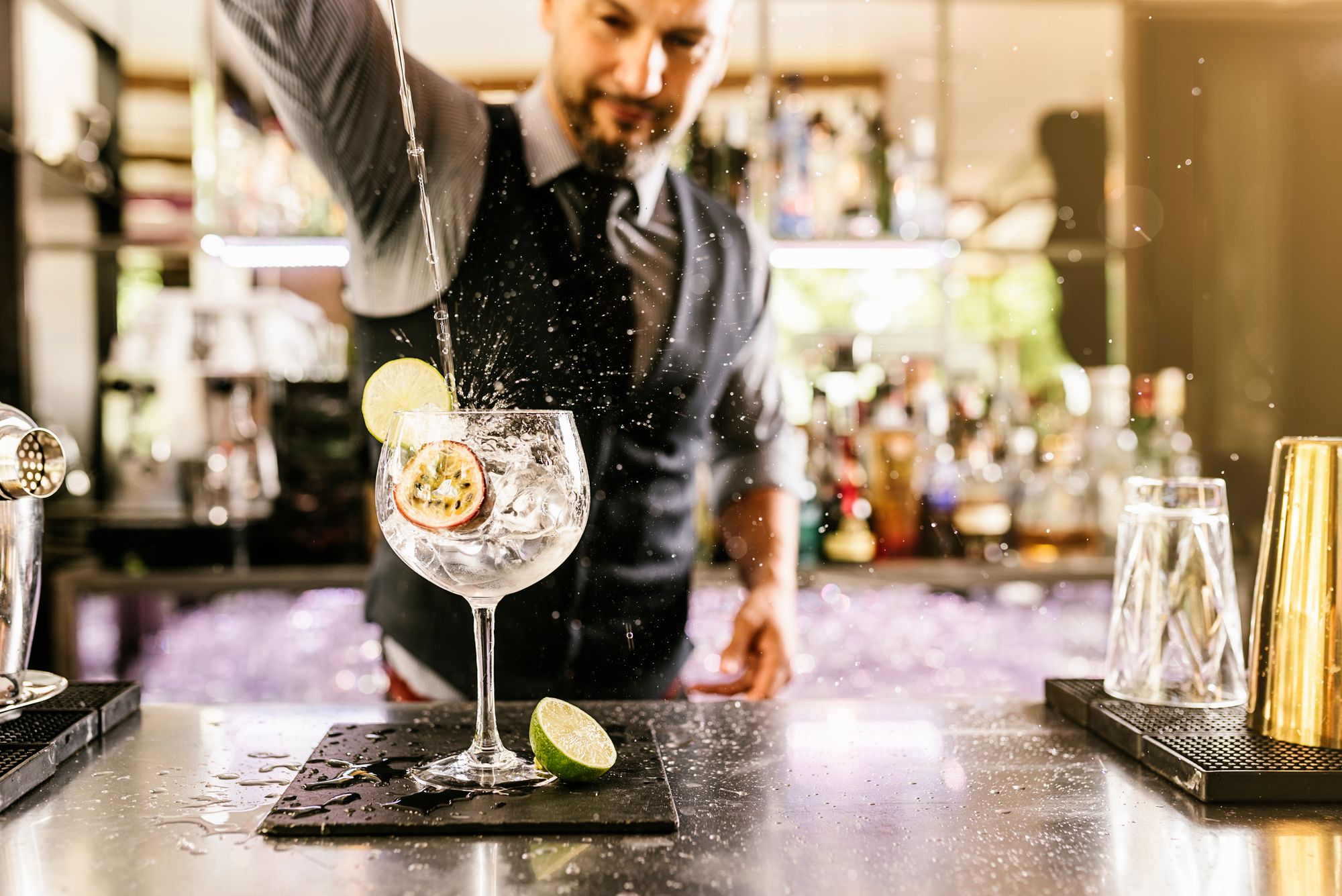 a man pouring a drink into a glass