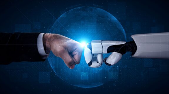 a robot and a hand touching a finger