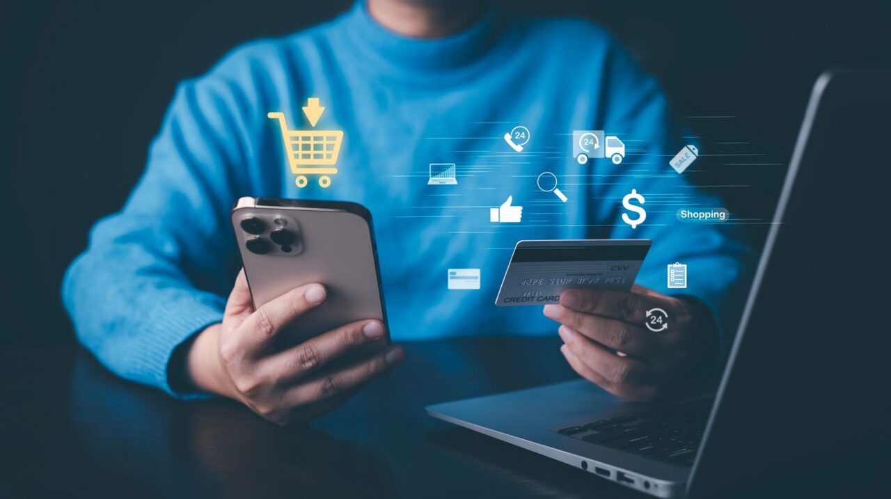 a person holding a credit card and a phone