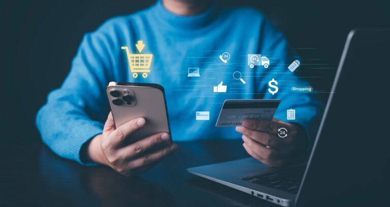 A Person Holding A Credit Card And A Phone