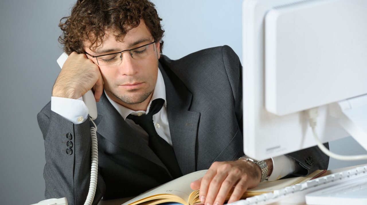 a man in a suit and tie on the phone