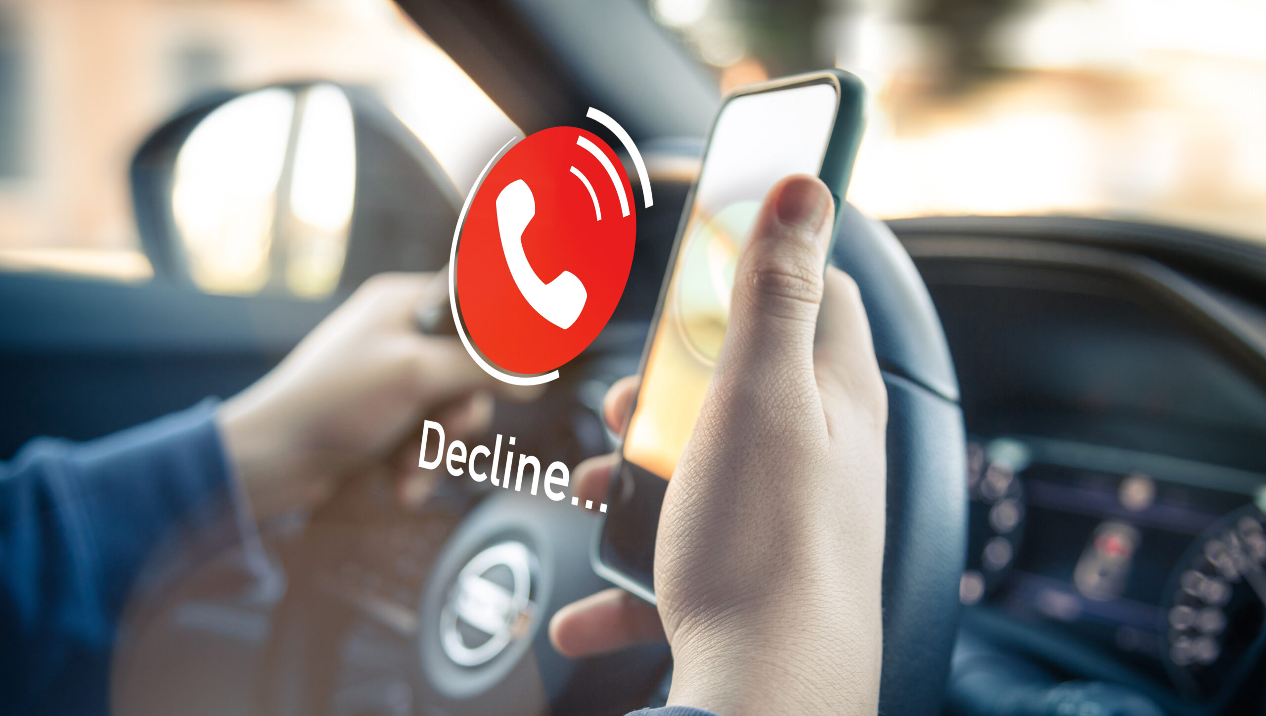 A Person Holding A Phone In A Car