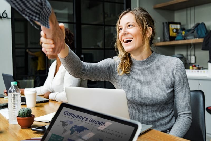 A Deep Dive Into Tecobi’s Lead Conversion Platform: Features And Benefits 2 Business People Working On A Laptop