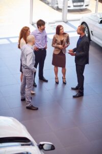 car dealer meeting with clients