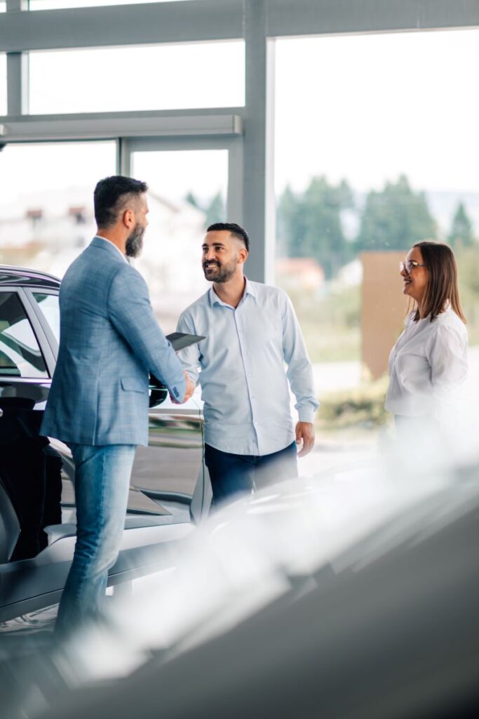 Turning Test Drives Into Deals: The Ultimate Guide To Lead Conversion In Automotive Sales 1 Handshake At Car Dealership