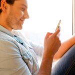 man reading personalized car-buying sms