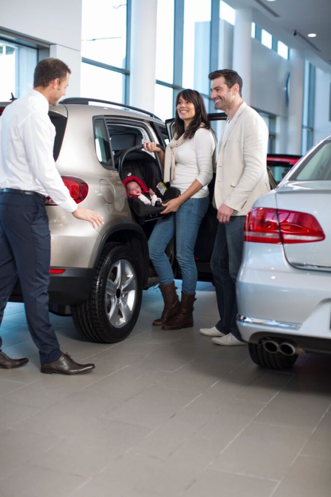 Turning Test Drives Into Deals: The Ultimate Guide To Lead Conversion In Automotive Sales 2 Salesman Chatting To Family With Baby