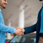 building relationships and shaking hands after a successful car buying