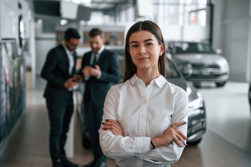 Sms Marketing 101: What Every Automotive Dealer Needs To Know 5 Woman Is Standing In Front Of Her Colleagues