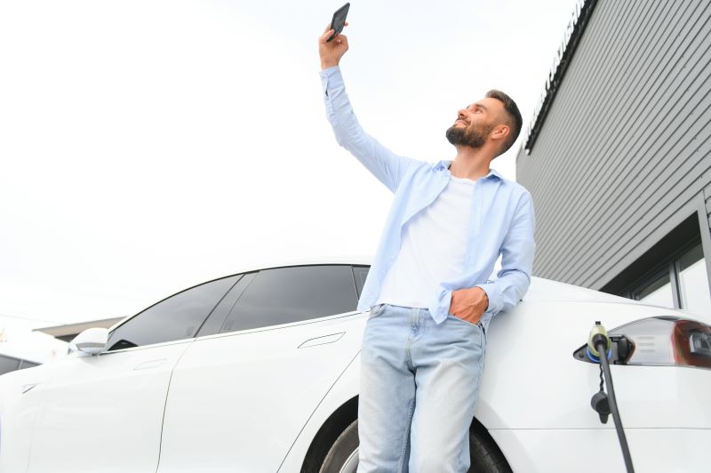 Why Your Dealership’s Lead Generation Is Failing—And How To Fix It 3 Casual Man With Smartphone Near Electric Car