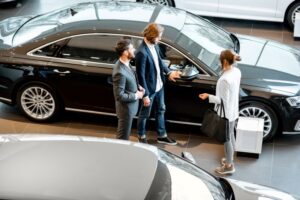 leads with salesperson in the car showroom