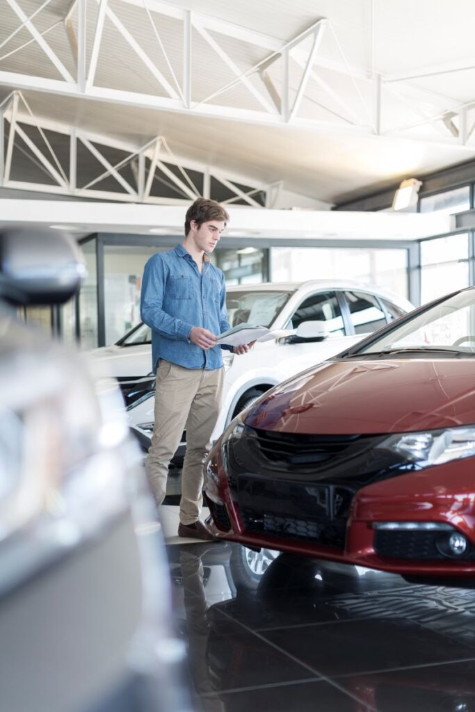 Man Checking Car Dealership Inventory