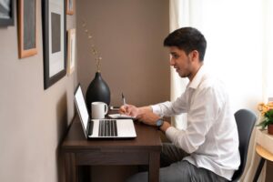man working at home from laptop and reading follow up message