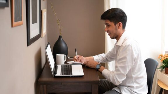 man working at home from laptop and reading follow up message