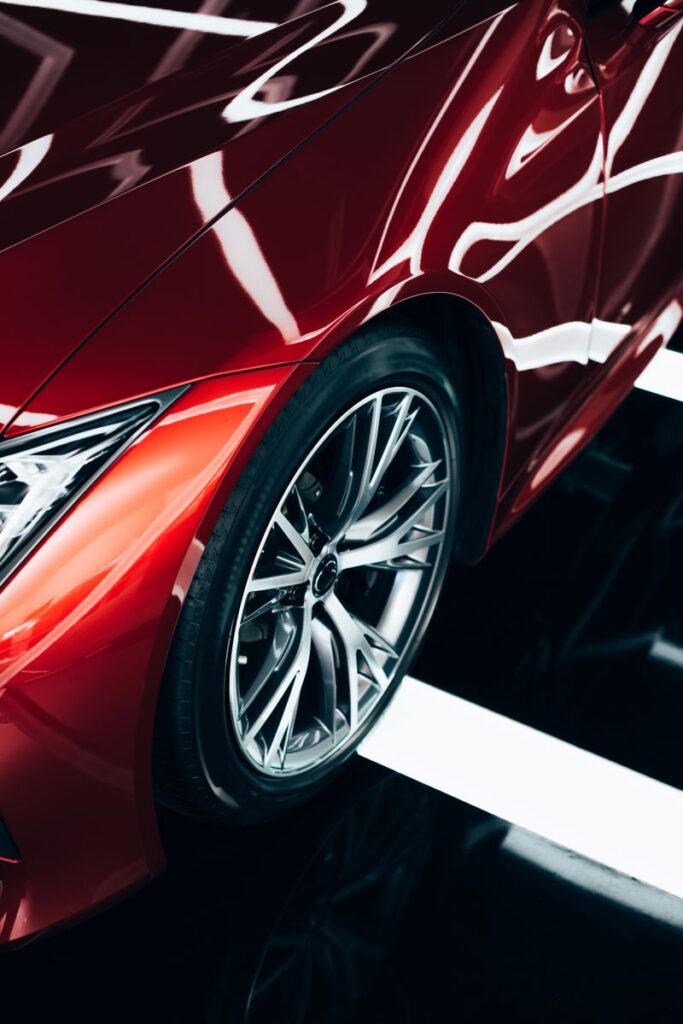 New Shiny Red Automobile With Metallic Wheel Content