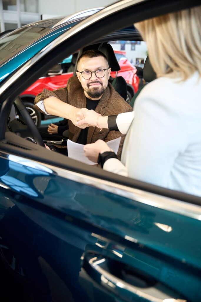 How To Build Lasting Relationships With Automotive Customers Using Tecobi 2 Two People Shaking Hands In A Car Dealership