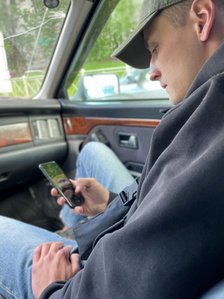 Top Automotive Lead Generation Strategies That Work In 2025 2 Young Man Watching The Cars On His Phone