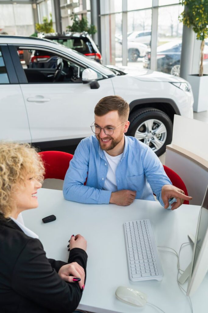 How To Build Lasting Relationships With Automotive Customers Using Tecobi 2 Car Dealership Manager With Client At Computer