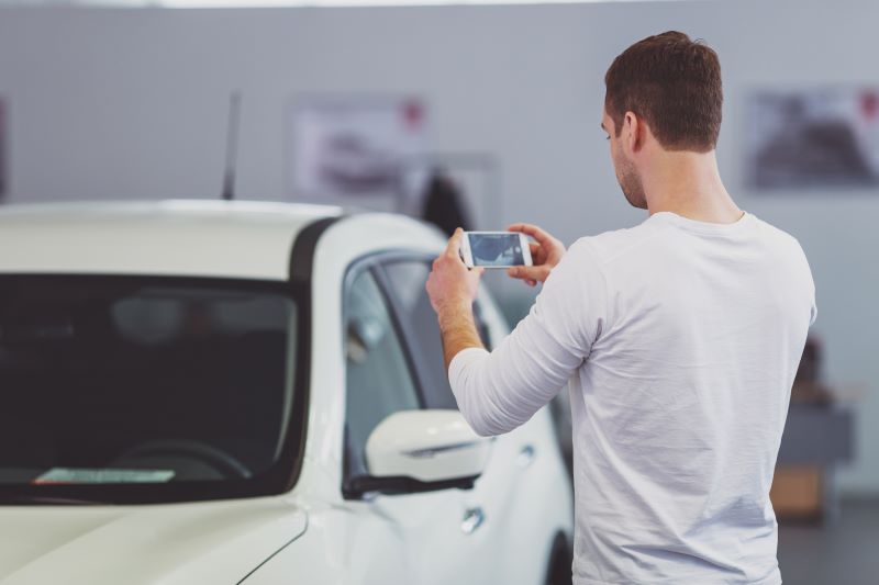 How Dealerships Can Leverage Social Media For Automotive Lead Generation 3 Man Taking A Photo Of The New Car