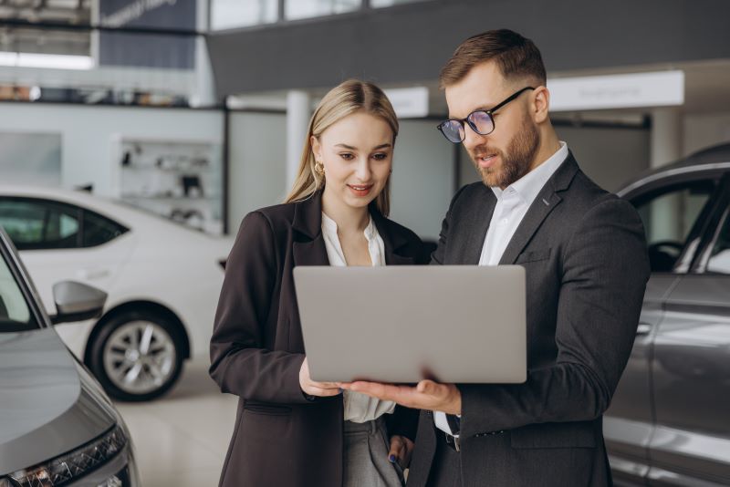 How Automotive Software Is Revolutionizing Car Sales In 2025 1 Two Workers Checking On New Software